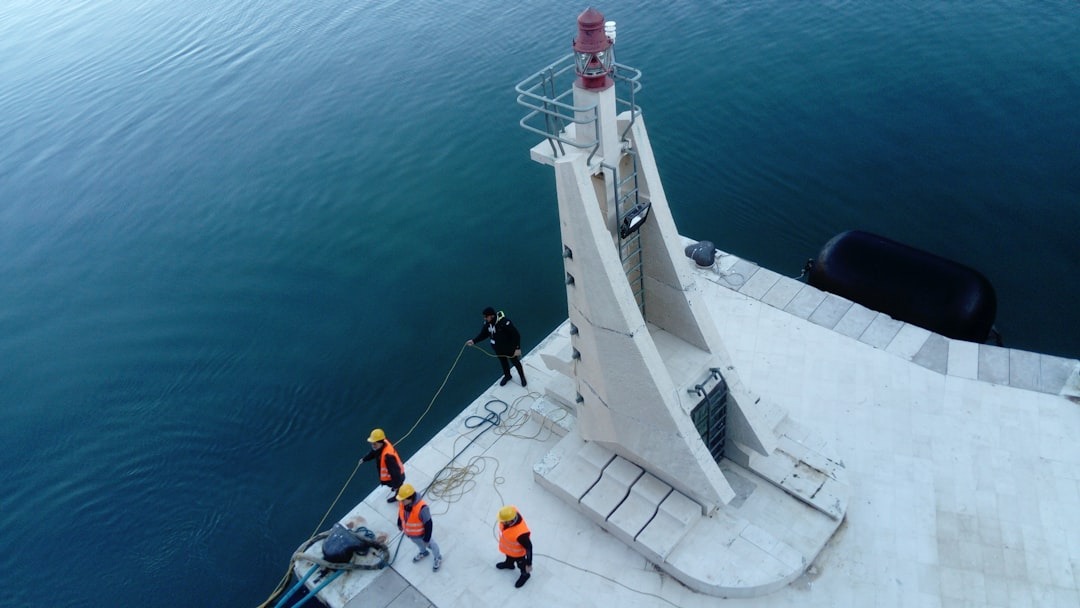 a group of people standing on top of a boat